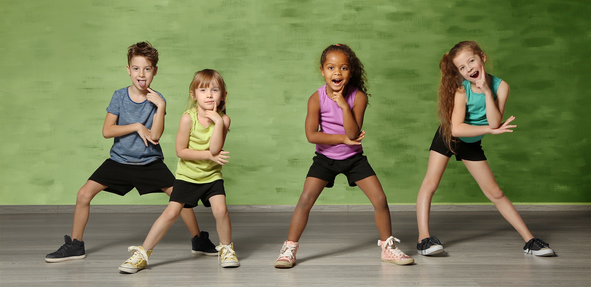Mut zum Tanzen mit groove2grow Vier Kinder posieren mutig und lustig in einer Tanzpause – Ermutigung zum Tanzen ohne Hemmungen